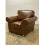 A brown leather upholstered easy chair, raised on block supports. H90cm, W105cm, D90cm.