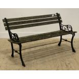 A traditional slatted teak and cast iron garden bench. L125cm.