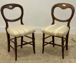 A pair of Victorian stained wood balloon back dining chairs, each with upholstered seats and