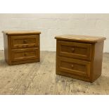 A pair of Canadian oak two drawer bedside chests. H60cm, W65cm, D40cm .