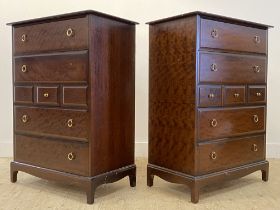 A pair of Stag minstrel chests, each fitted with four long and three short drawers, raised on