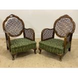 A pair of 1930's walnut framed bergere chairs, each with cane panelled back and sides, raised on