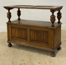 An early 20th century oak monks bench, the folding back rest carved with linen fold panels, above