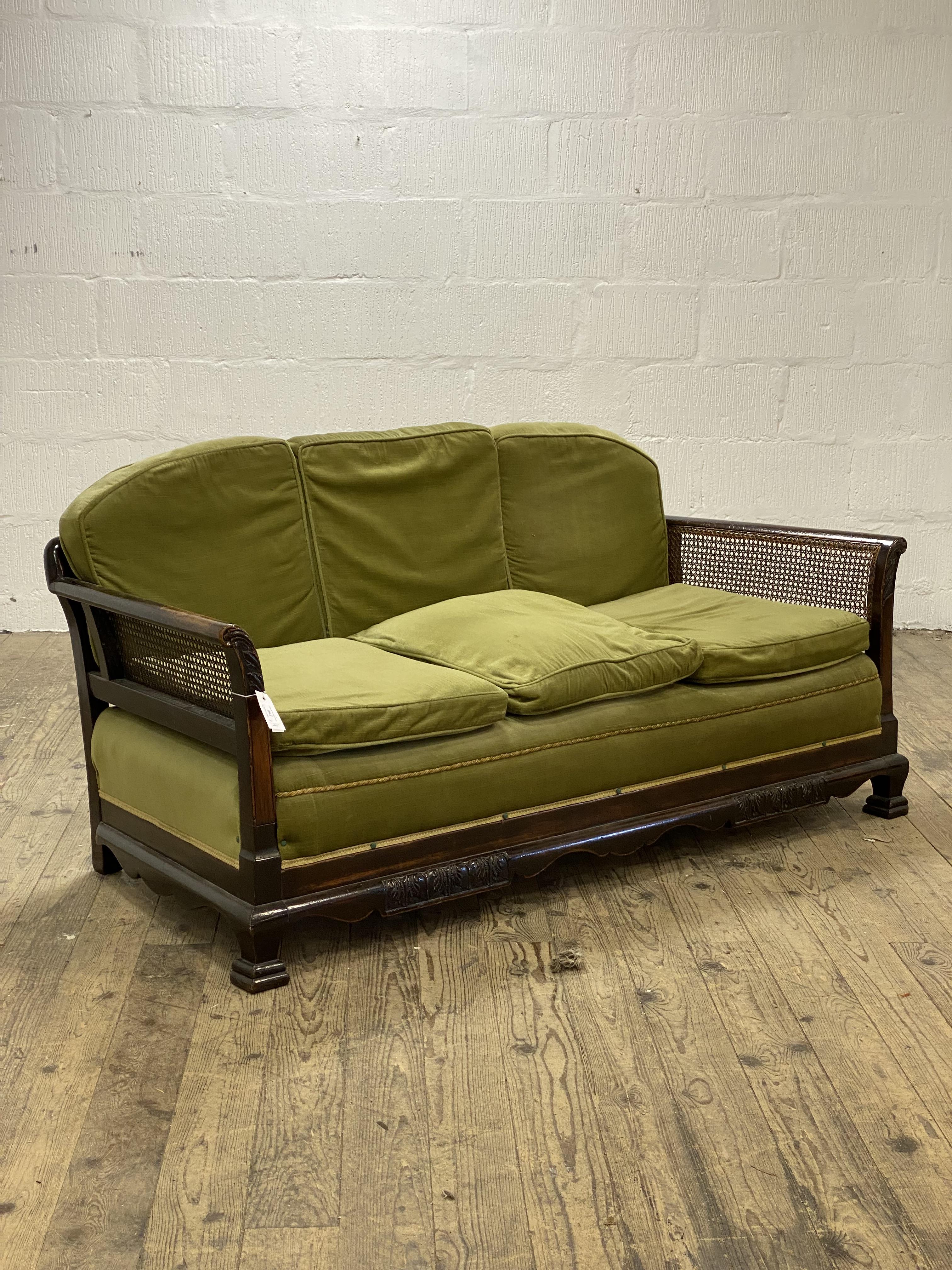 A 1920's walnut bergere sofa, with undulating back rail and cane panelled back and sides, raised - Image 2 of 2
