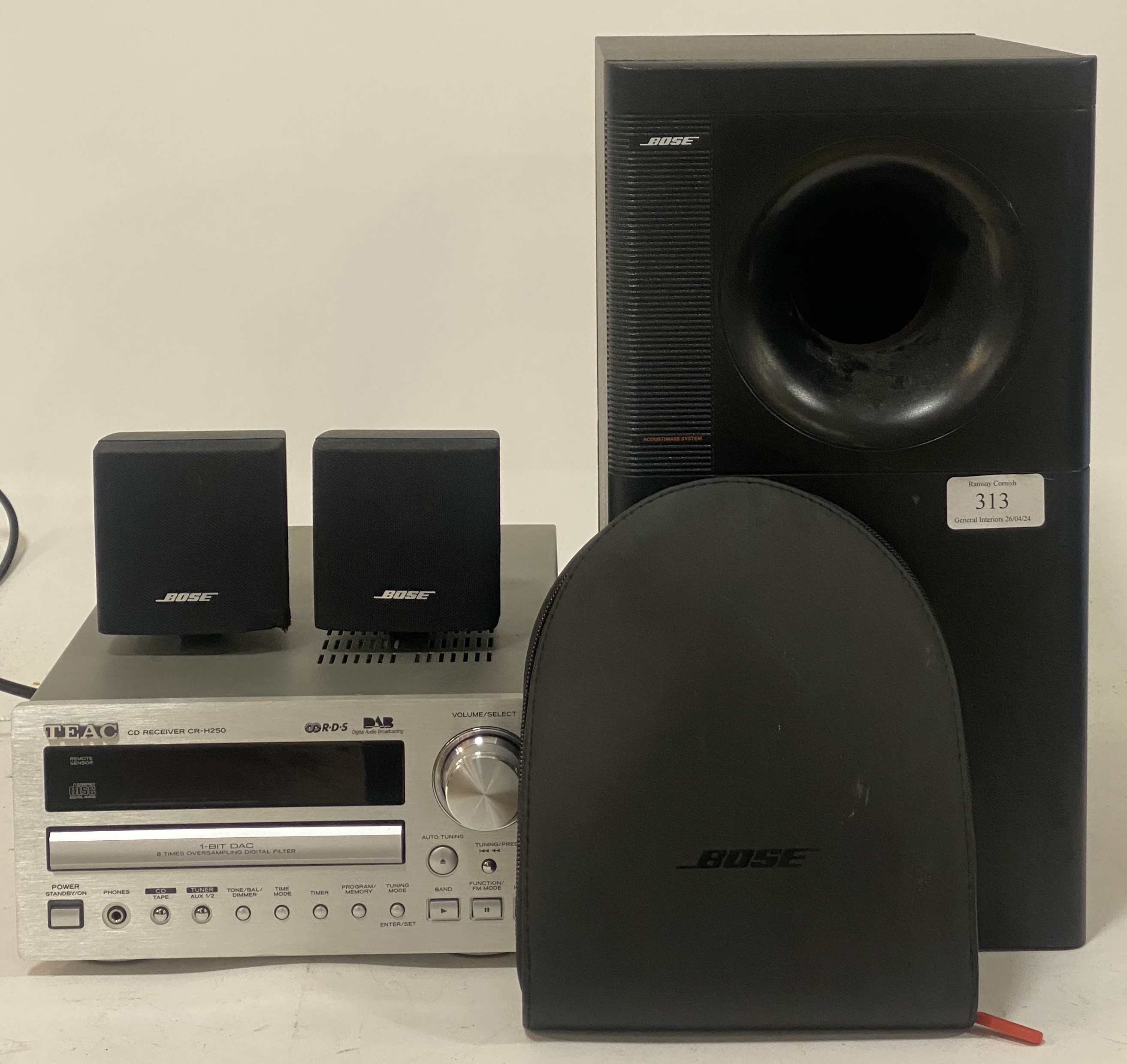 A Bose Acoustimass audio system, comprising a subwoofer and two cube satellite speakers (3) together