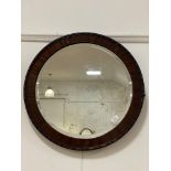 A 20th century mahogany framed circular wall mirror with bevelled glass. D62cm