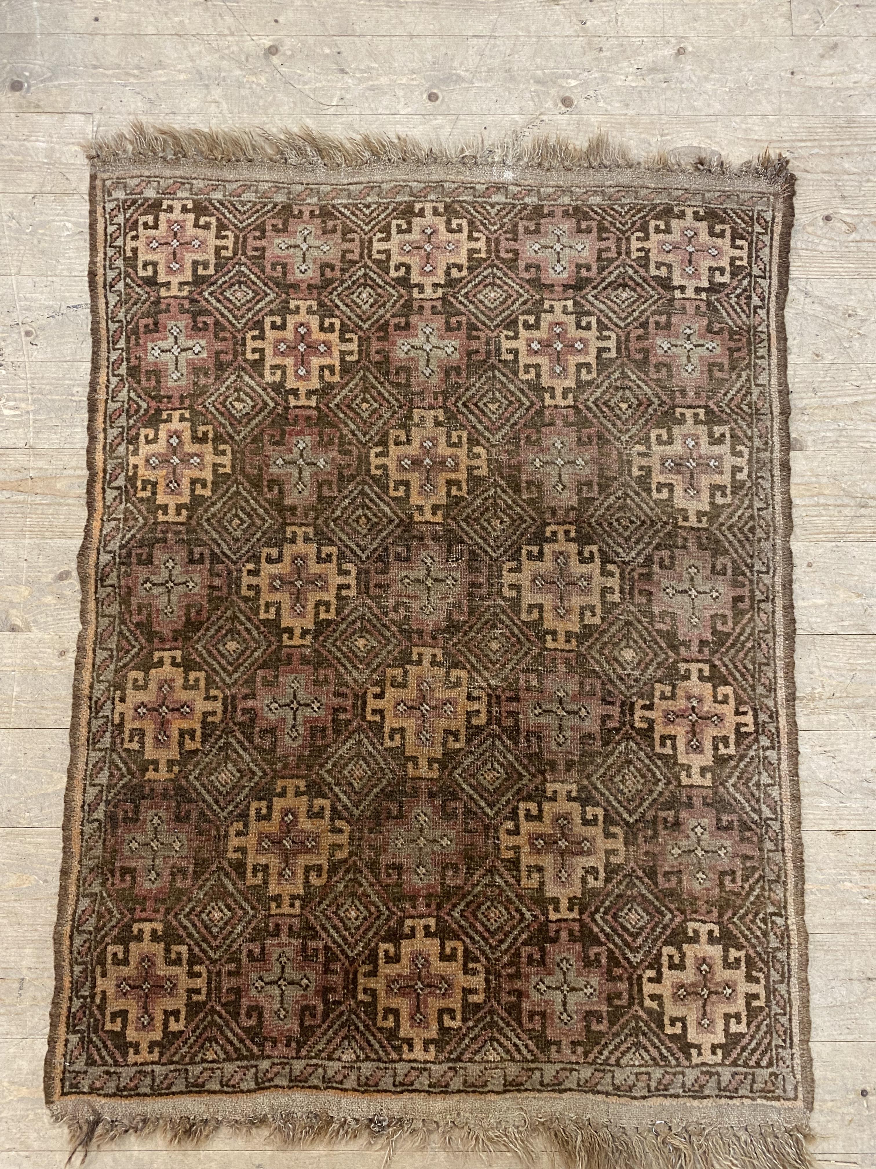 A hand knotted Turkish rug of repeating geometric design. 120cm x 88cm.