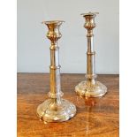 A Victorian pair of Sheffield plated telescopic candle sticks on tapered columns and scalloped