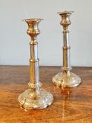 A Victorian pair of Sheffield plated telescopic candle sticks on tapered columns and scalloped