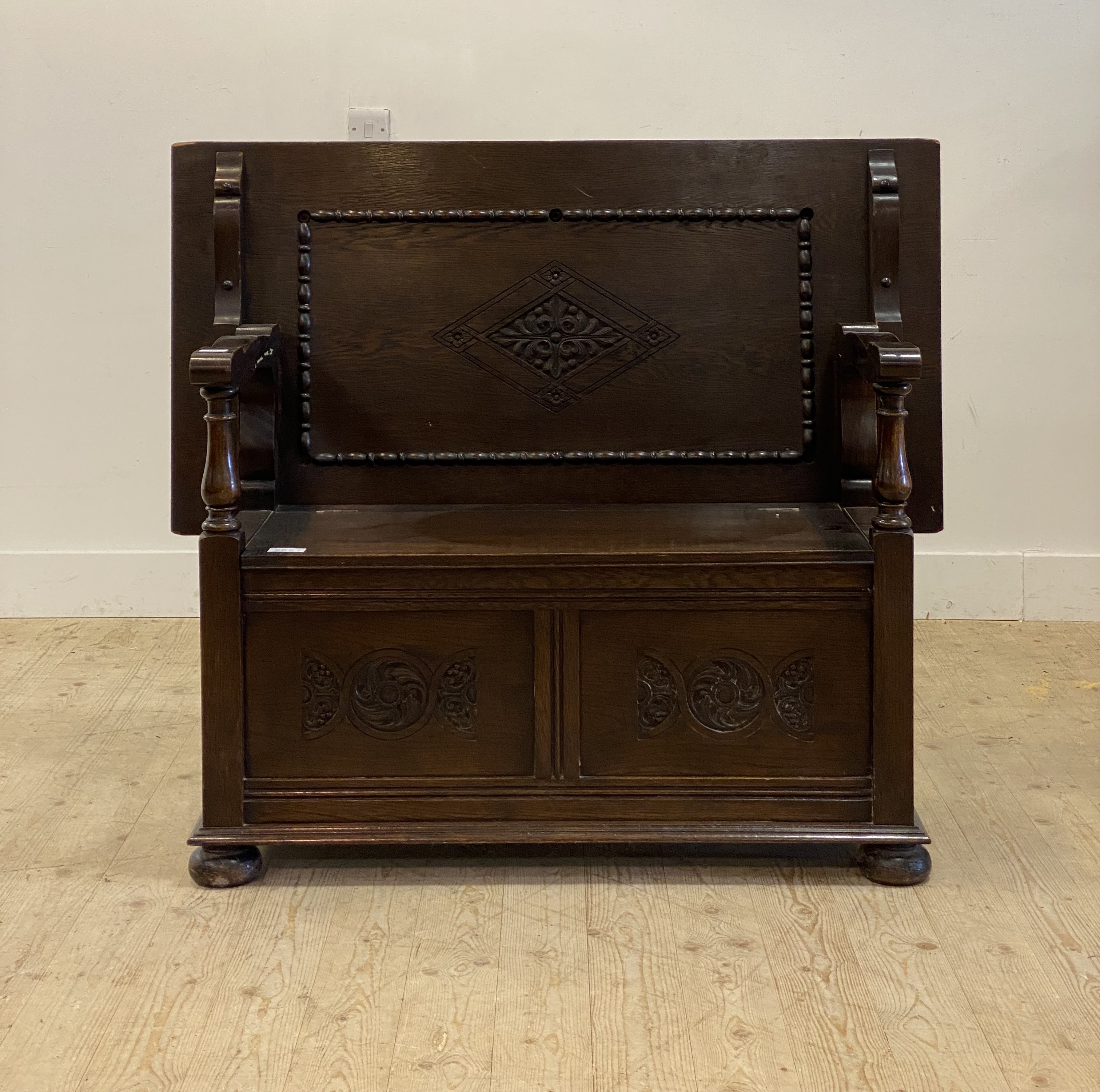 An early to mid 20th century oak monks bench, the fold over top / back rest carved with lozenge - Image 2 of 2