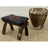 An African zebra skin drum of tapered cylindrical form (H45cm) together with a folding hardwood