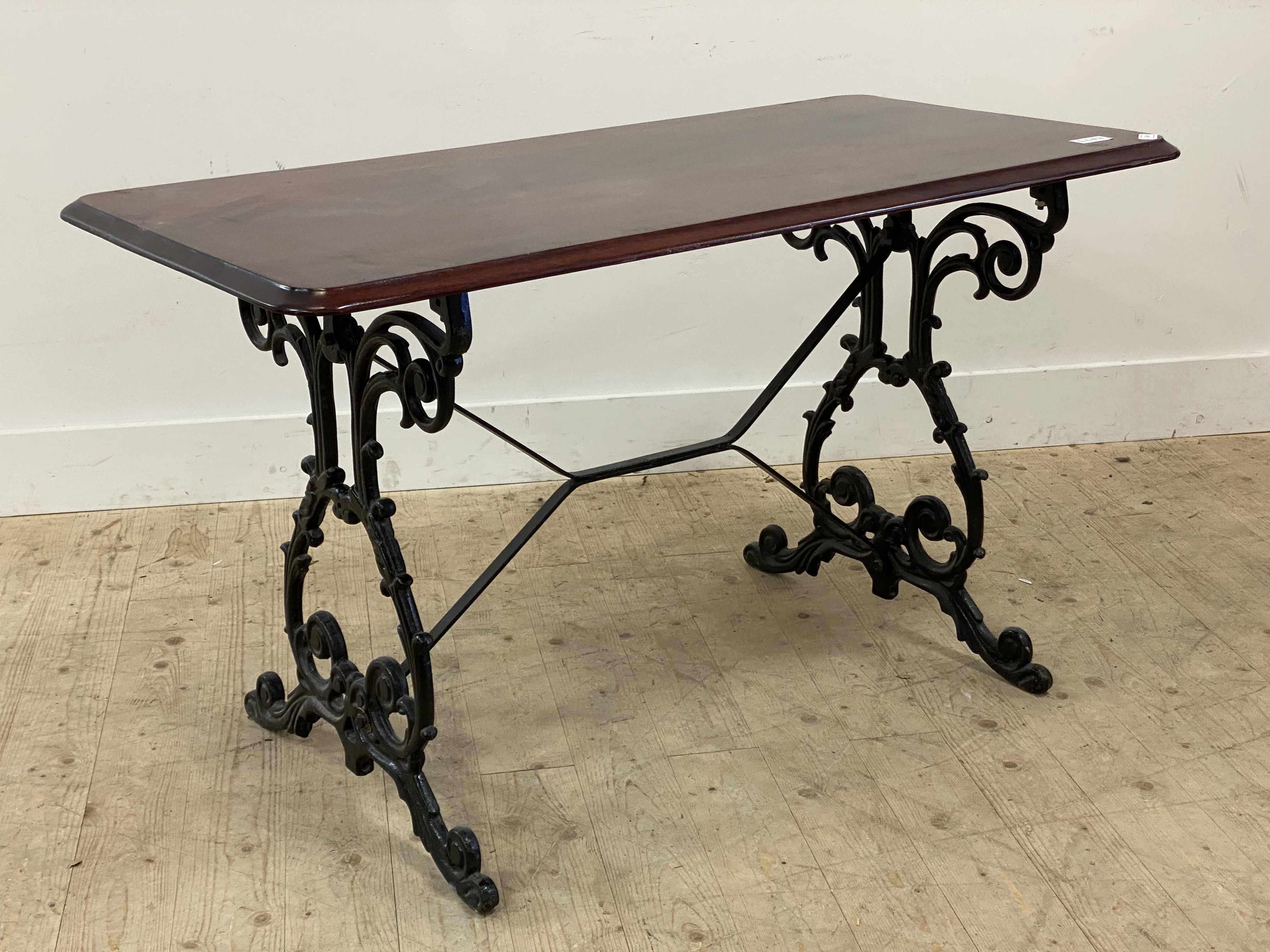 A Victorian style pub table, the mahogany top raised on a cast iron base. H70cm, W121cm, D62cm.