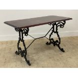 A Victorian style pub table, the mahogany top raised on a cast iron base. H70cm, W121cm, D62cm.