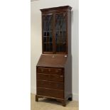 A George III mahogany bureau bookcase, the dentil cornice above two tracery glazed doors enclosing