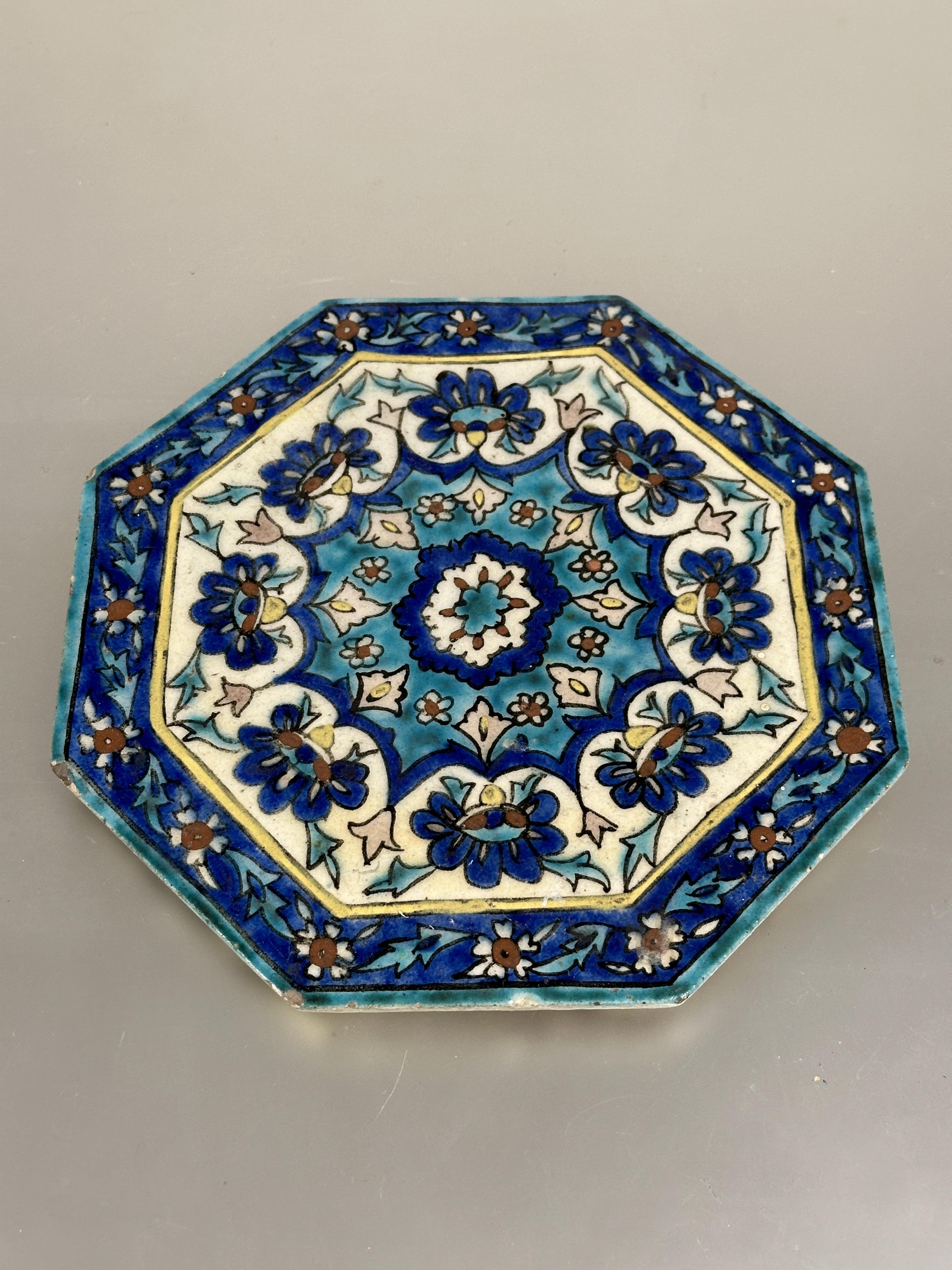 A Iznik glazed pottery octagonal tile with central flower enmclosed within a lotus leaf and flower - Image 4 of 7