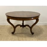 A Victorian oak centre table, the circular top raised on three scrolled supports united by