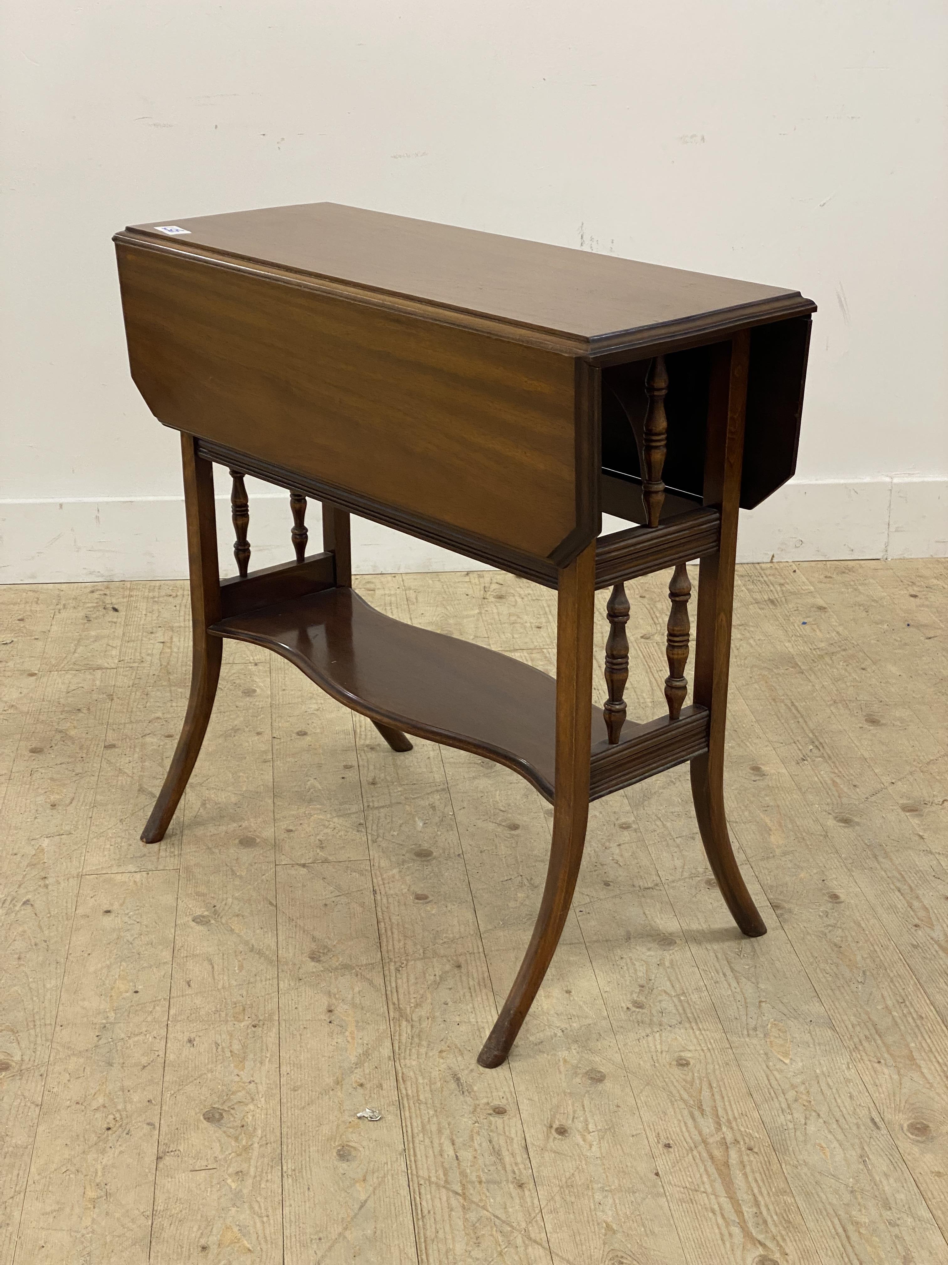 An Edwardian mahogany Sutherland table, the top with twin drop leaves, raised on square tapered