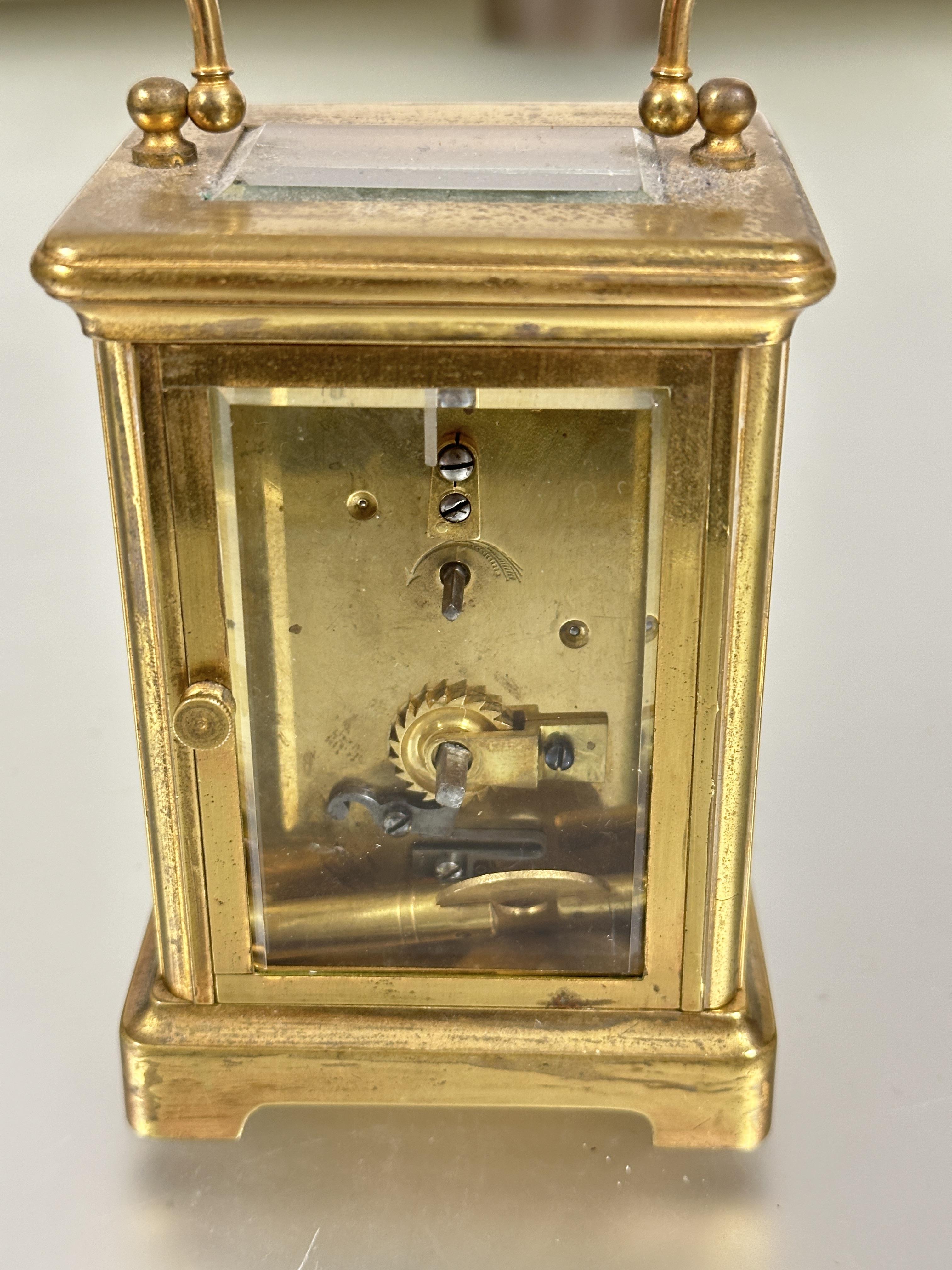 A modern brass four glass clock with folding carry handle to top white enamel dial with roman - Image 2 of 5