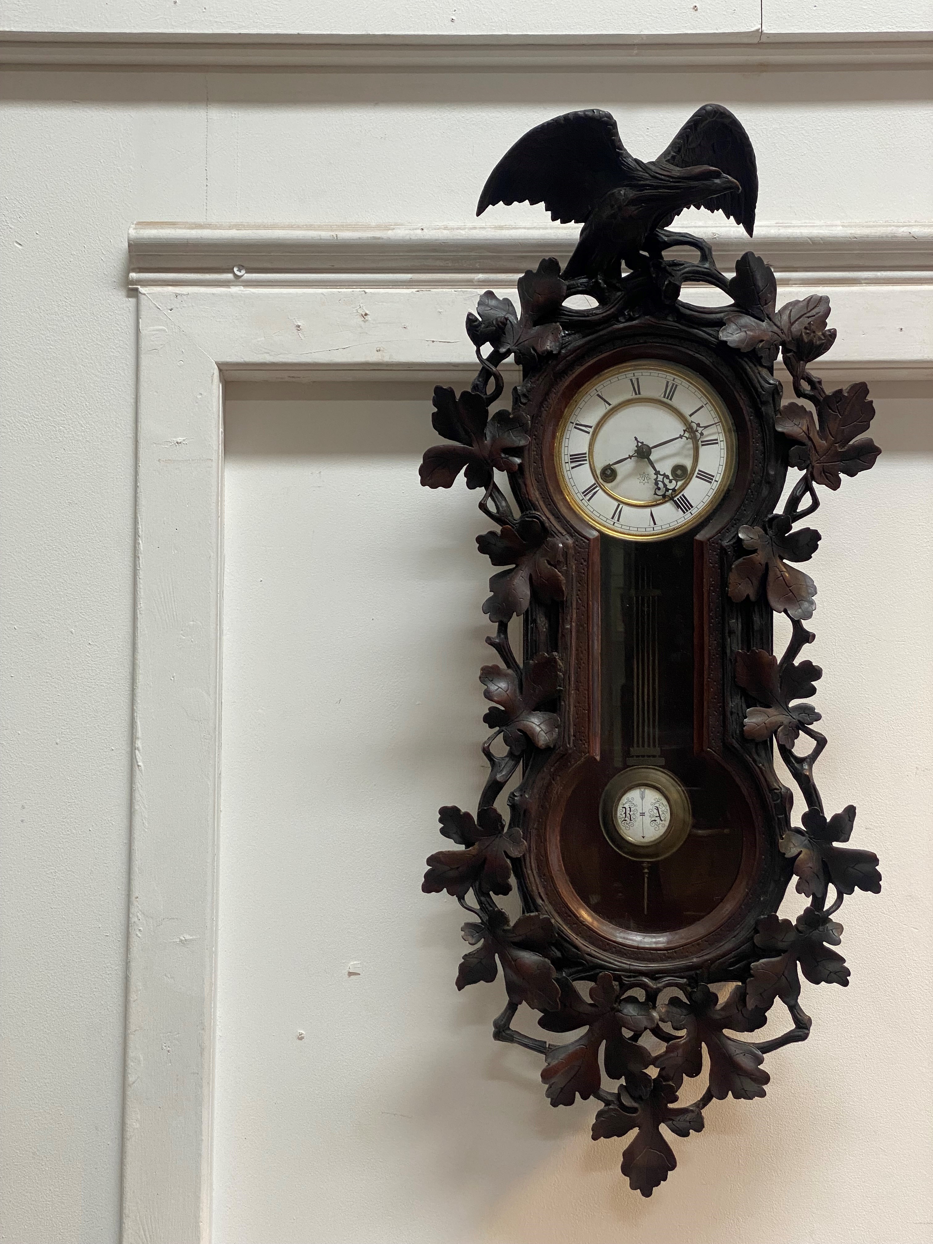 A Junghans Vienna type regulator wall clock, circa 1860's, the walnut case well-carved with an eagle