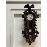 A Junghans Vienna type regulator wall clock, circa 1860's, the walnut case well-carved with an eagle