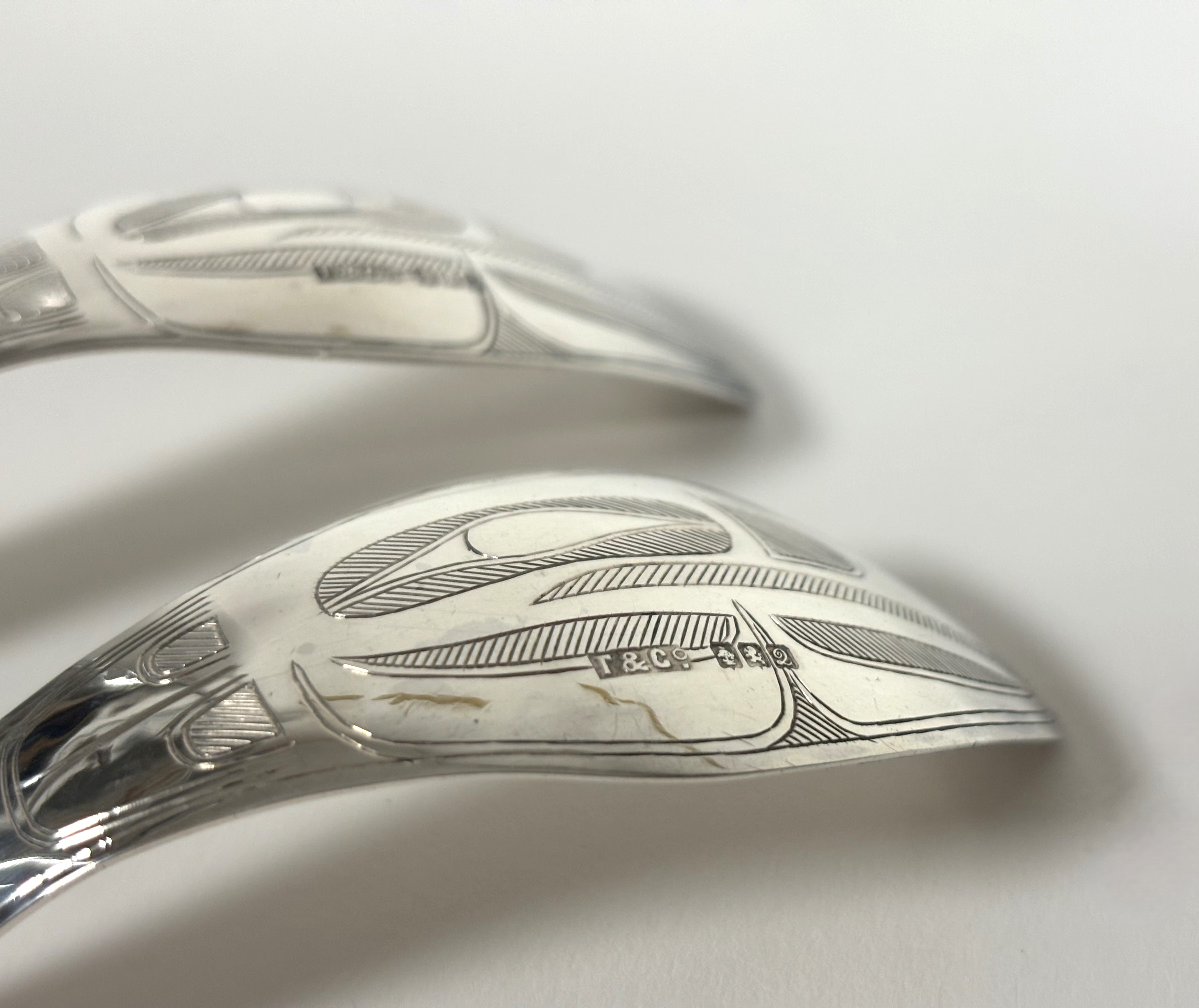 An unusual cased pair of George V silver serving spoons, Robert Tennant & Co., Glasgow 1913, the - Image 6 of 6