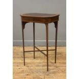 An Edwardian mahogany work table, the rectangular top with canted corners having satinwood and