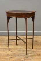 An Edwardian mahogany work table, the rectangular top with canted corners having satinwood and
