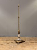 An Aesthetic period gilt-brass telescopic floor lamp, converted to electricity, with well-cast