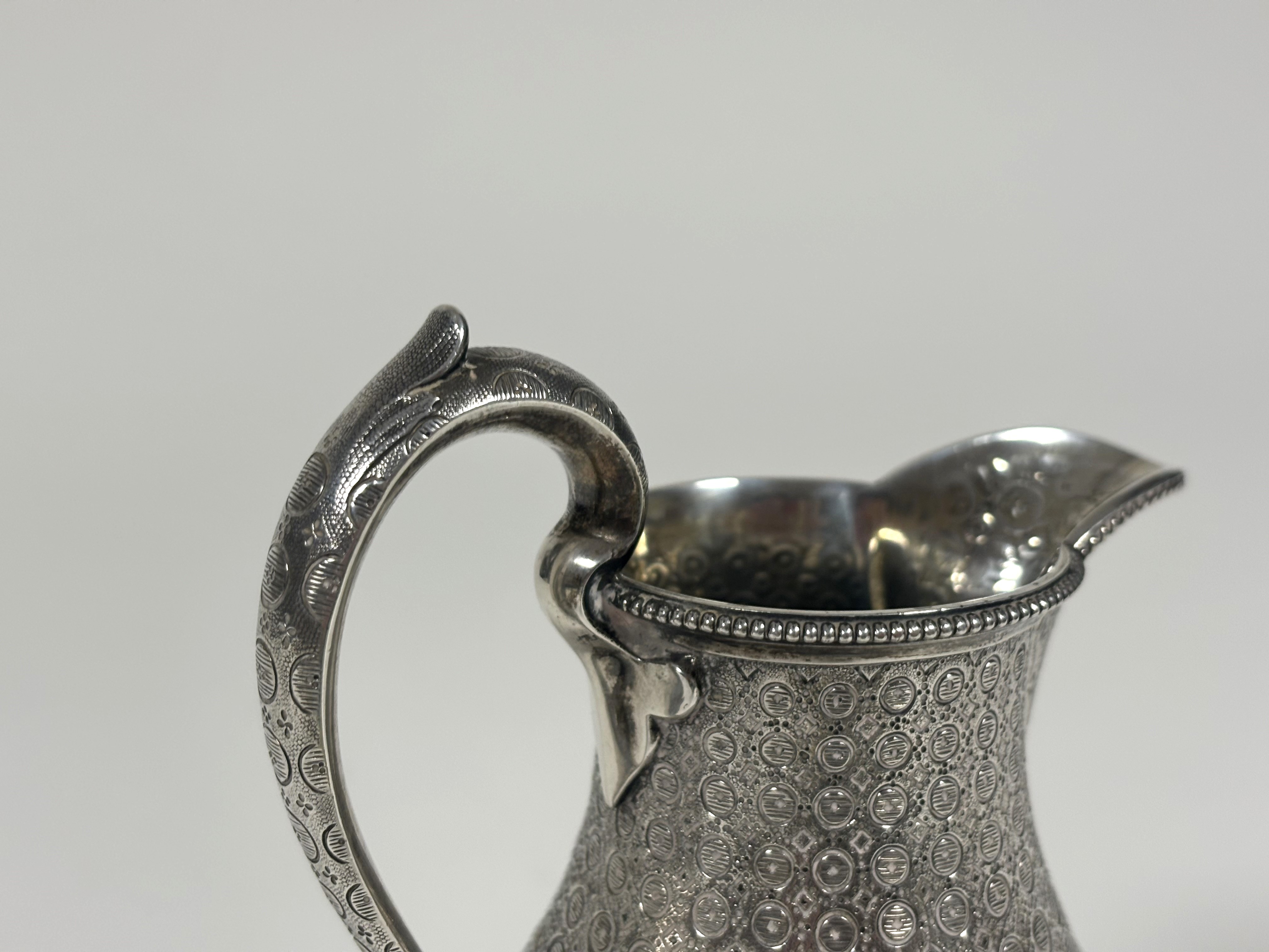 A mid-Victorian silver baluster cream jug, Edward & John Barnard, London 1863, densely engraved with - Image 4 of 5