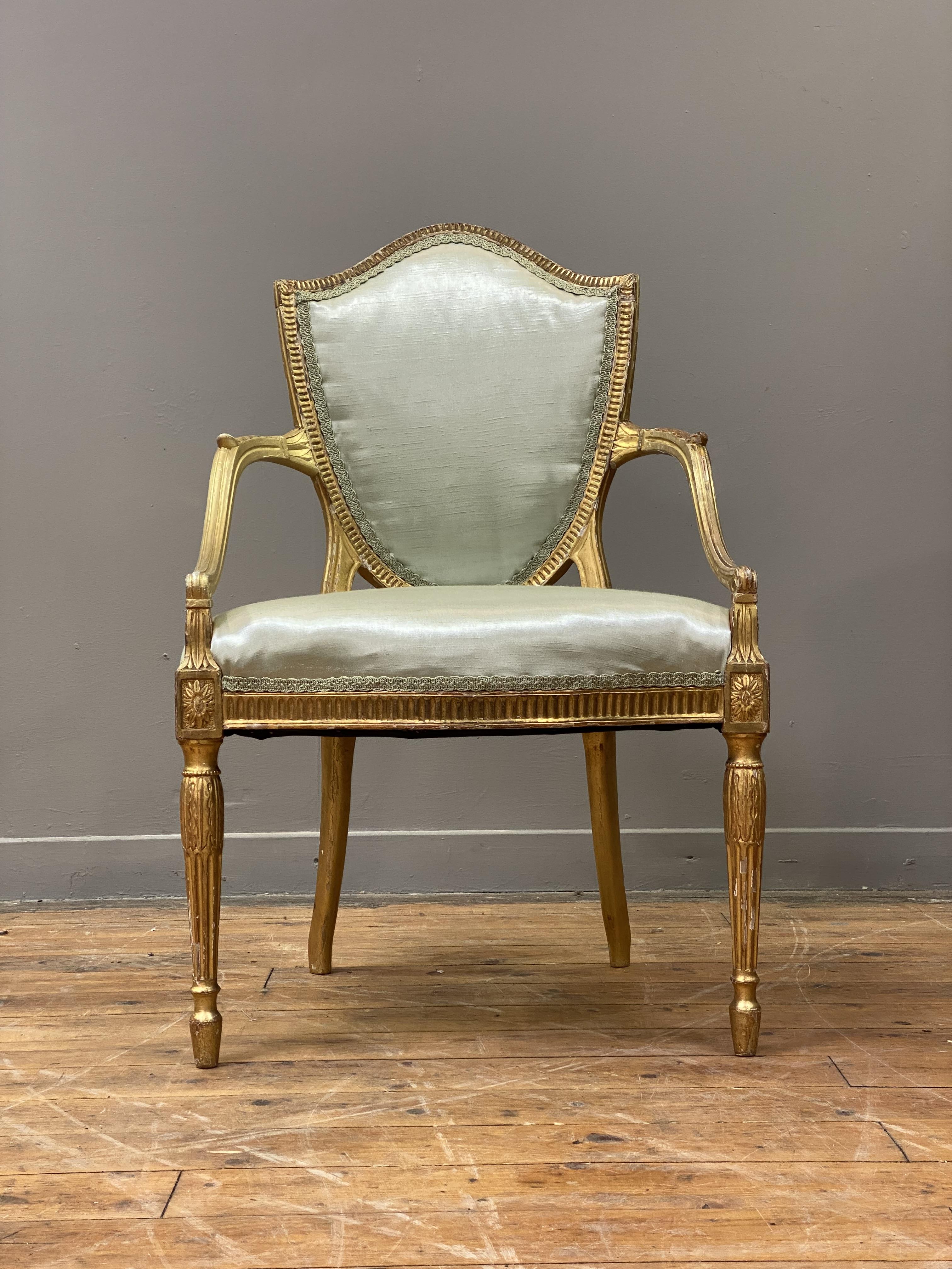 A George III giltwood and gesso elbow chair in the manner of Thomas Hepplewhite, late 18th - Image 3 of 4