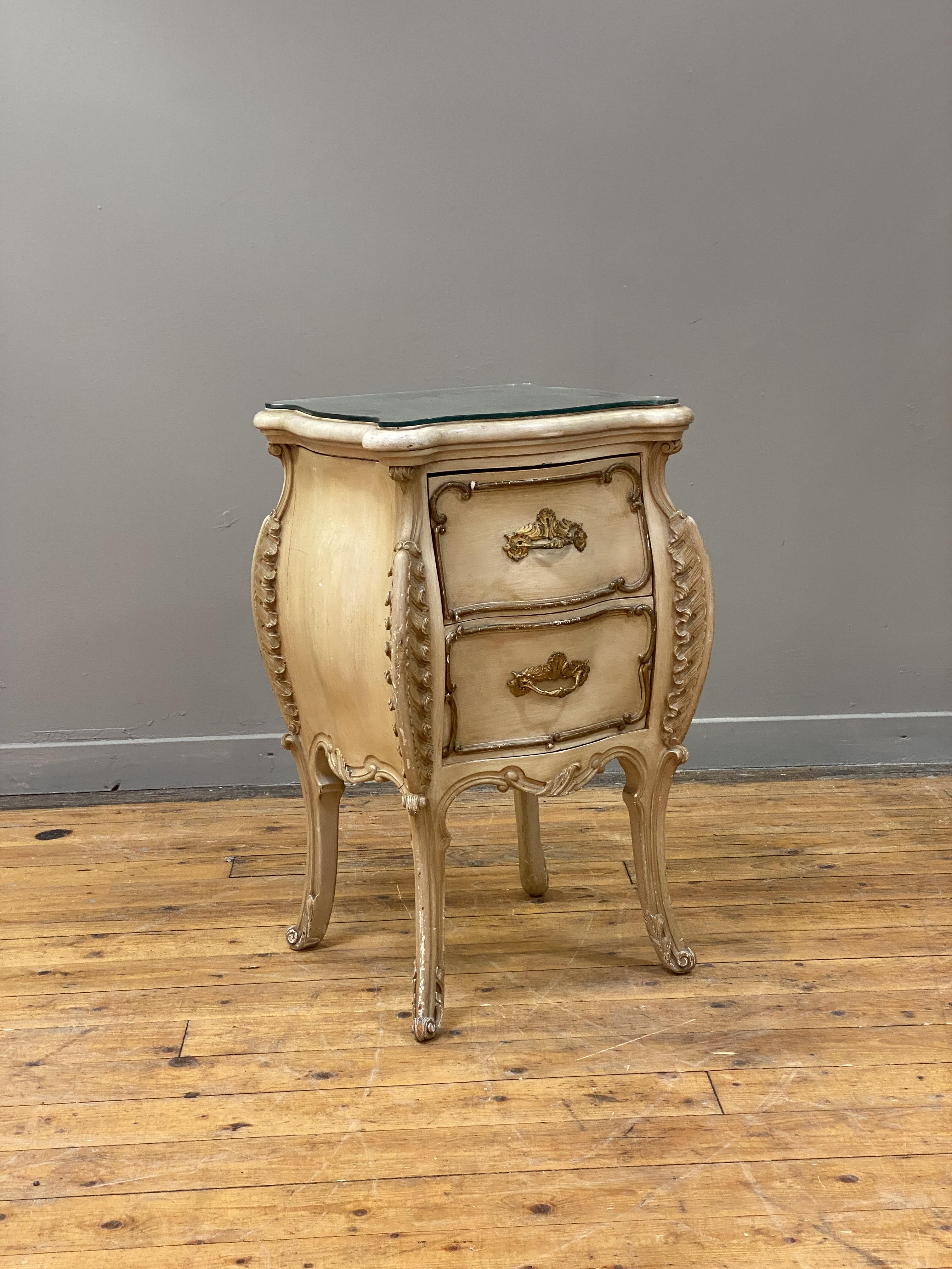 A Neo-Rococo bed side chest of bombe form, late 19th century, cream painted and parcel gilt