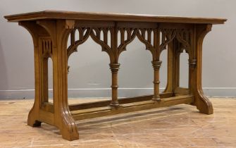 An Edwardian Gothic Revival oak hall table of rectangular outline, the top with chamfered edge above