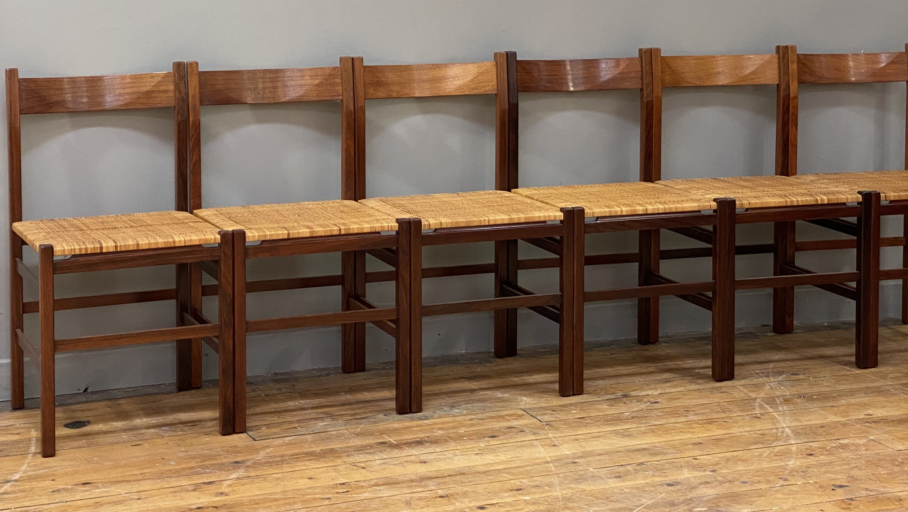 A set of six Danish rosewood dining chairs, circa 1960's, the curved and shaped crest rail above a