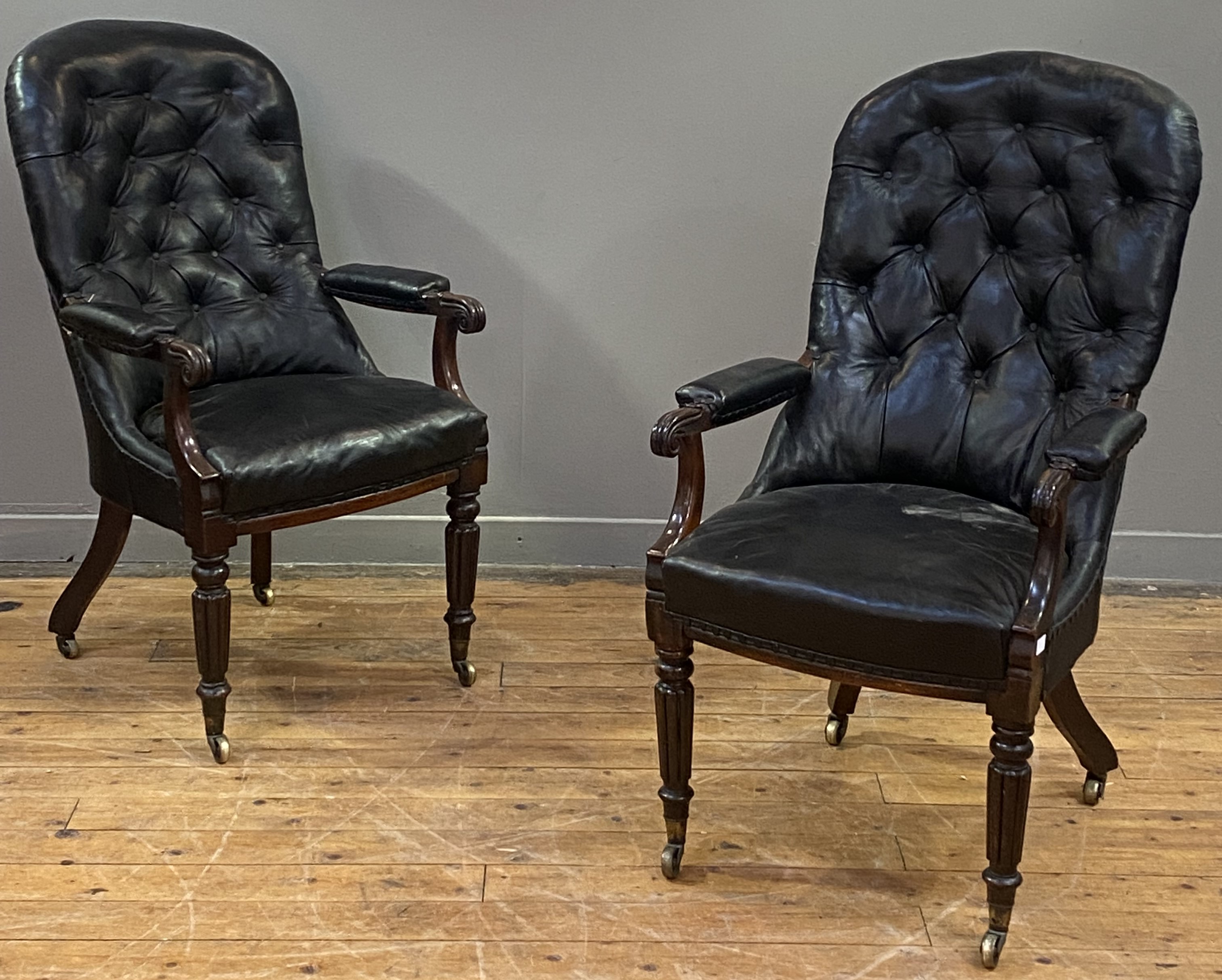A pair of William IV rosewood library chairs, the button back, seat and elbow rests upholstered in