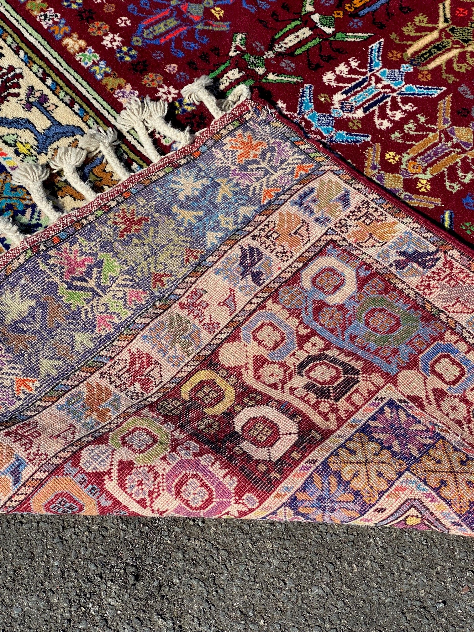 A large hand knotted Caucasian carpet, decorated with repeating motifs in a vibrant palette. ( - Image 2 of 2