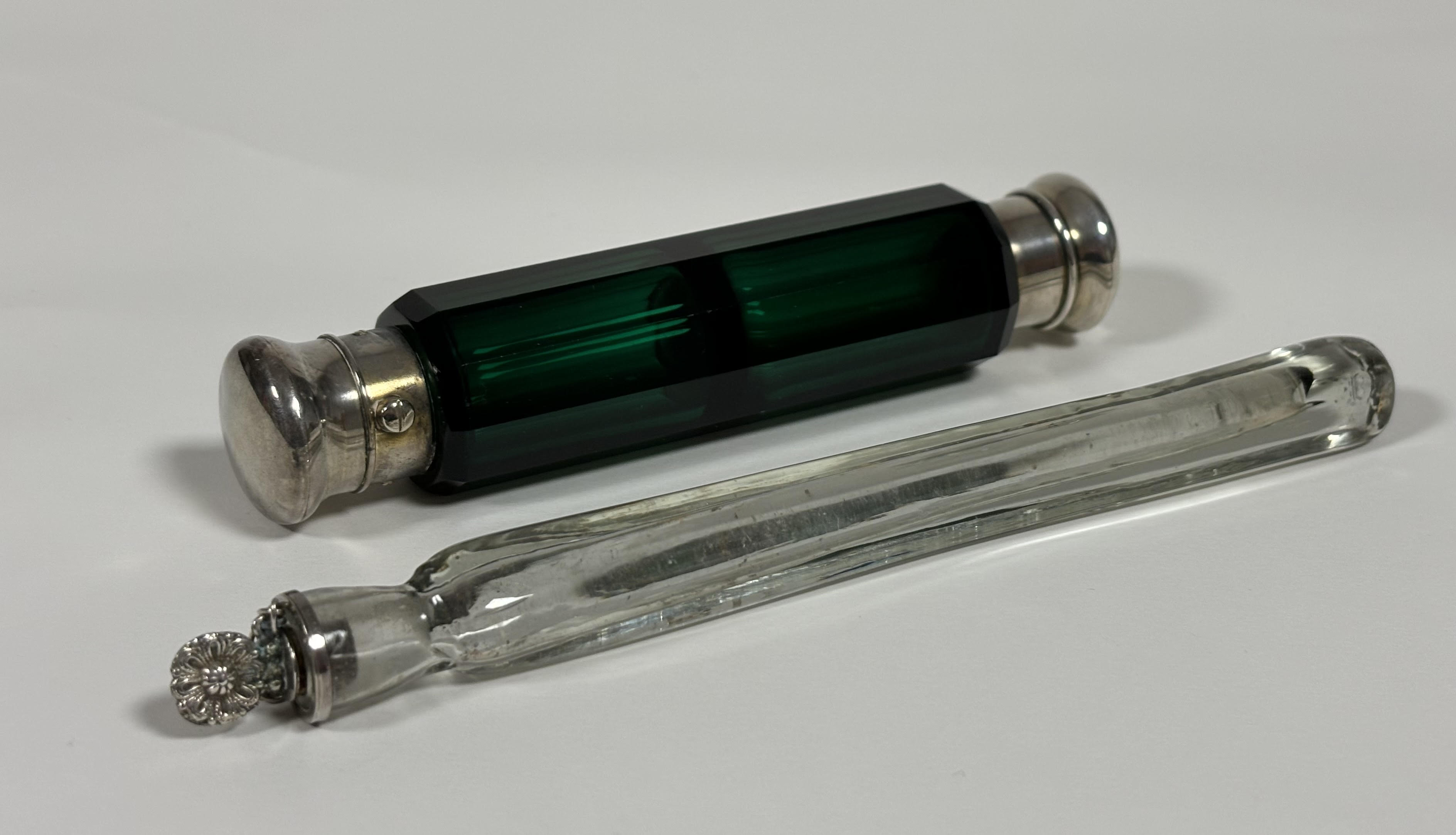 Two late 19th century scent bottles: the first a double-ended bottle in green glass, of faceted