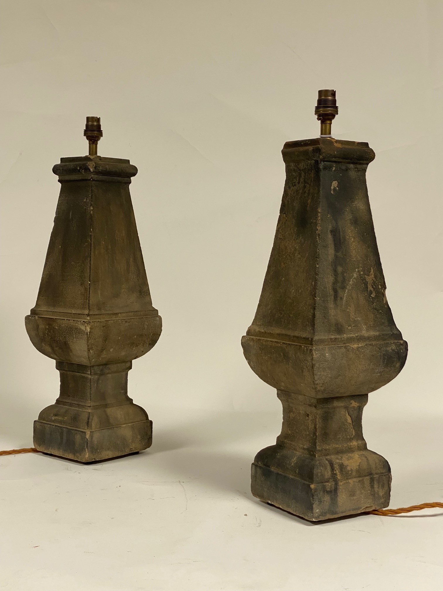 A pair of 19th century carved stone balustrades, of faceted baluster form, converted to table lamps.