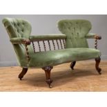 A Victorian rosewood salon settee, the twin spoon back, united by a spiral turned gallery and