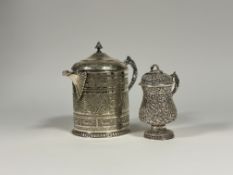 A large 19th century Indian white metal jug and cover, with presentation inscriptions relating to