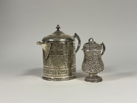 A large 19th century Indian white metal jug and cover, with presentation inscriptions relating to