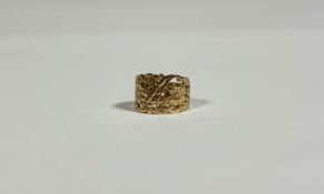 An early 19th century gold ring, the tapering band pierced and scroll and leaf-cast, further