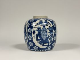 A Chinese blue and white porcelain ovoid jar, probably Kangxi period, painted with shaped cartouches