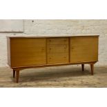 Alfred Cox, a mid century walnut sideboard, the rectangular top with concave moulded edge above