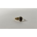 An Edwardian 18ct gold mourning ring, the central glazed hair locket within a band of seed pearls on