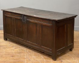 An English oak coffer of pegged and jointed construction, 17th century, the hinged lid opening on
