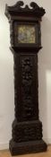 An English stained oak longcase clock, 18th century and later, the case profusely carved with