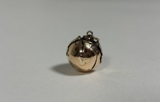 A yellow metal Masonic ball pendant, of characteristic form, unmarked. Diameter 16mm, 15 grams.