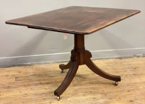 A Regency mahogany tilt top breakfast table, the rectangular top raised on a turned column and