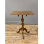 A 19th century oak snap top table, the square top on a turned column and triple splay supports.