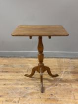 A 19th century oak snap top table, the square top on a turned column and triple splay supports.